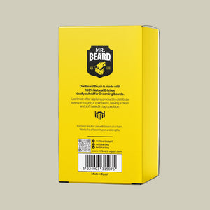 Yellow packaging of a beard brush with branding and text on a white background