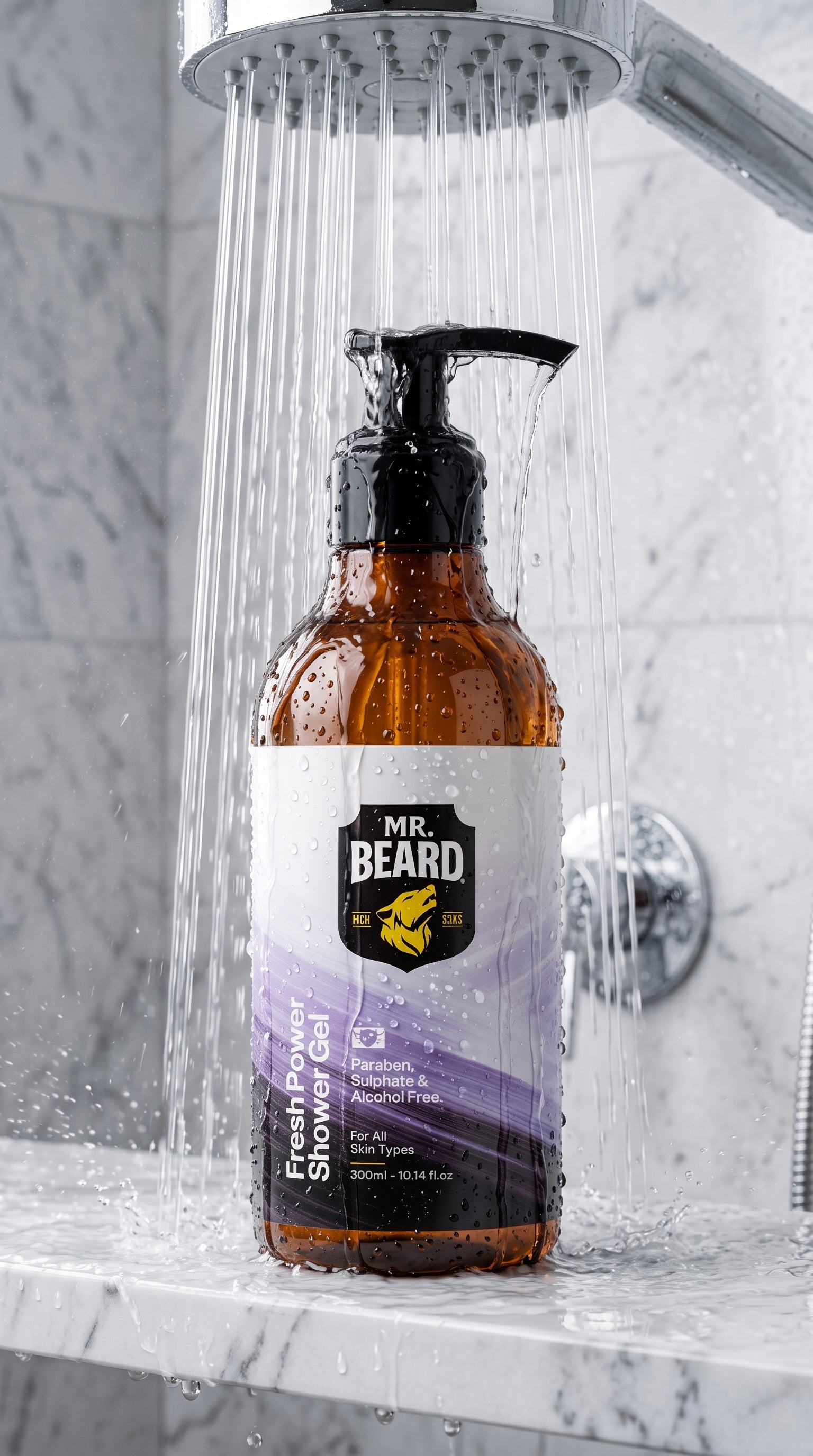 Mr. Beard Fresh Pimp Shower Gel in an amber glass pump bottle with a black dispenser, set under a running shower head on a marble countertop.