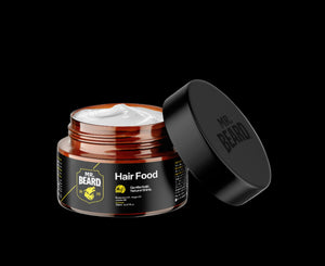 A jar of Hair Food leave-in moisturizing cream with the lid off, showing the product inside. The jar is labeled with the product name and has a dark cap.
