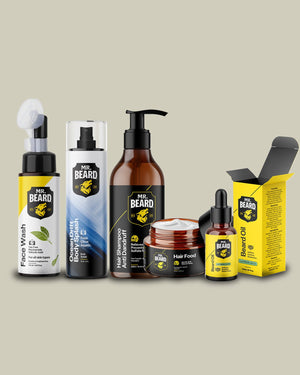 A group of Mr. Beard personal care products arranged on a plain beige background, including a facial wash pump bottle, beard balm spray bottle, beard shampoo bottle, hair food jar, beard oil dropper bottle, and a yellow beard oil box.