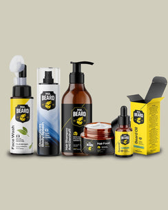 A group of Mr. Beard personal care products arranged on a plain beige background, including a facial wash pump bottle, beard balm spray bottle, beard shampoo bottle, hair food jar, beard oil dropper bottle, and a yellow beard oil box.