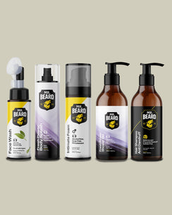 Five Mr. Beard grooming products arranged in a row against a solid beige background: beard wash, fresh body spray, intimate foam, facial shower foam, and anti-dandruff shampoo.