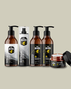 A set of Mr. Beard grooming products including shower gel, body spray, shampoo, conditioner, and hair food in amber bottles and jars with black pumps and lids, arranged on a solid beige background.